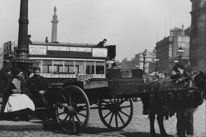 A pony cart is parked in front of a horse-drawn tram in 1895. The Alexander theatre on the right became the well known variety theatre, the Empire.  (Photo by J. Burke/Hulton Archive/Getty Images)