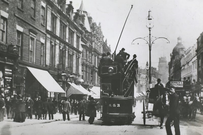 One of the first electric tramcars proceeds down Lord Street in Liverpool, circa 1902. A hansom cab rank is seen in the centre of the street, and on the right is one of the horse-drawn tramcars. (Photo by Hulton Archive/Getty Images)