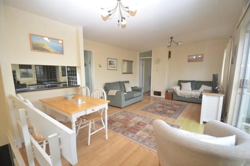 Take a brisk walk up a flight of stairs from the ground floor and be met with this stunning open plan lounge and breakfast area (left of the picture)