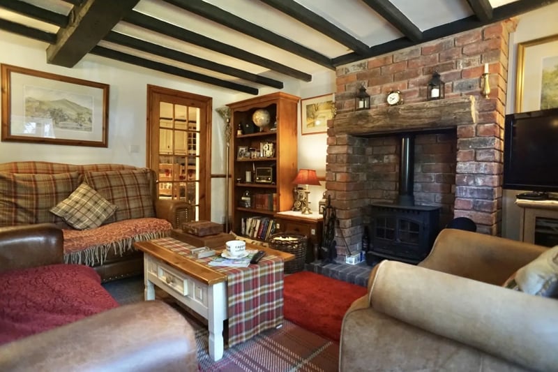 The property comes with a lounge with exposed beams and a log burner.