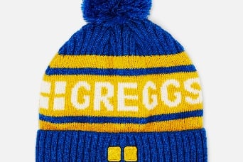 “To complete your Greggs look from head to toe, look no further than this blue and yellow bobble hat. Ideal for keeping you warm whether you’re out Christmas shopping or getting stuck into a snowball fight.”