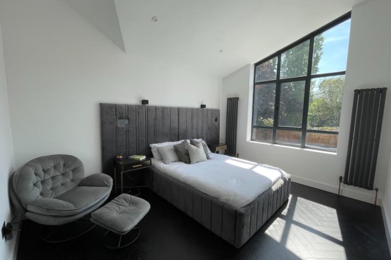 The property has five bedrooms, each with ample space and natural light. The black vertical radiators are a modern, quirky feature.