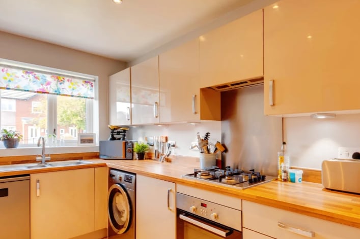 The spacious kitchen features fitted appliances and cabinets. 