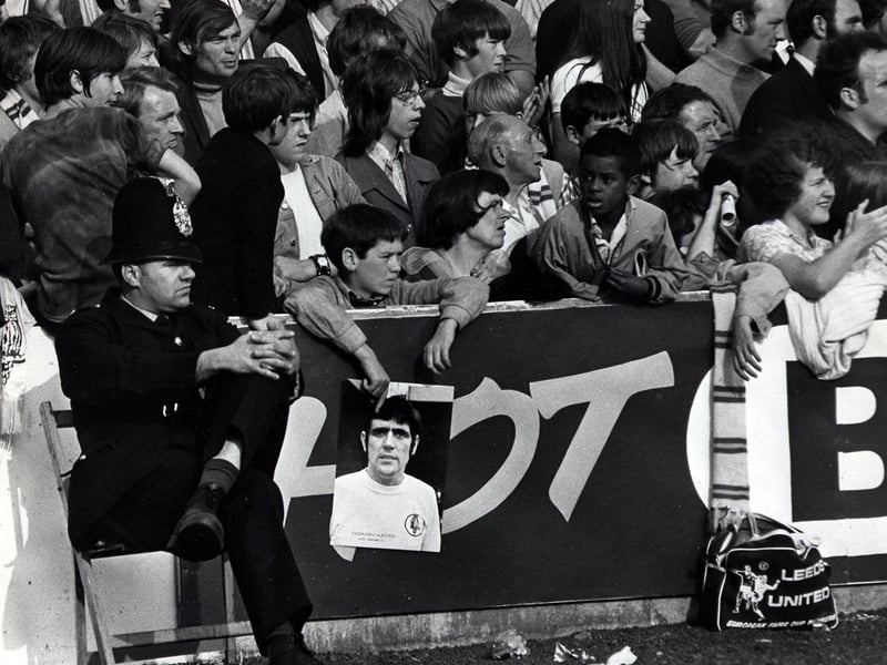 A young fan waits at the barrier in the hopes of meeting his hero, Norman Hunter.