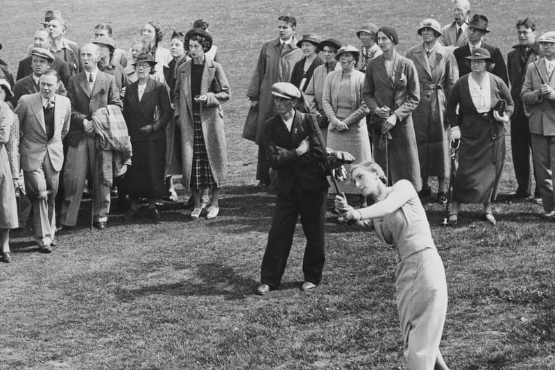 A crowd of spectators watch as Bridget Newell of Great Britain hits off the fairway to the 6th green during the Women’s Amateur Golf Championship on 15th May 1936 at the Southport and Ainsdale Golf Club.