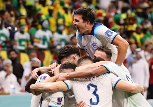 Harry Maguire of England celebrates with team mates after his captain Harry Kane of England scores their teams second goal during the FIFA World Cup Qatar 2022 Round of 16 match between England and Senegal at Al Bayt Stadium on December 04, 2022 in Al Khor, Qatar. (Photo by Clive Brunskill/Getty Images