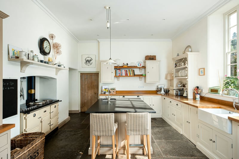 The kitchen is smart with a tiled floor and central reservation