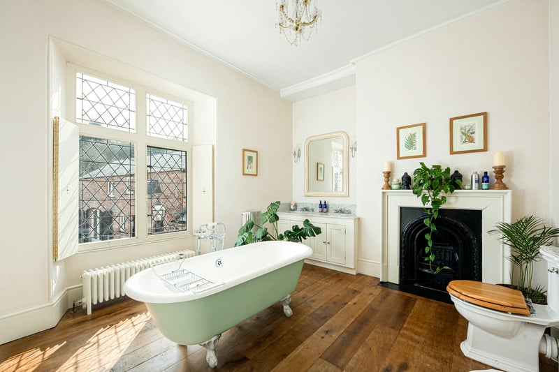 Bath like a king in the middle of this large bathroom with a fireplace