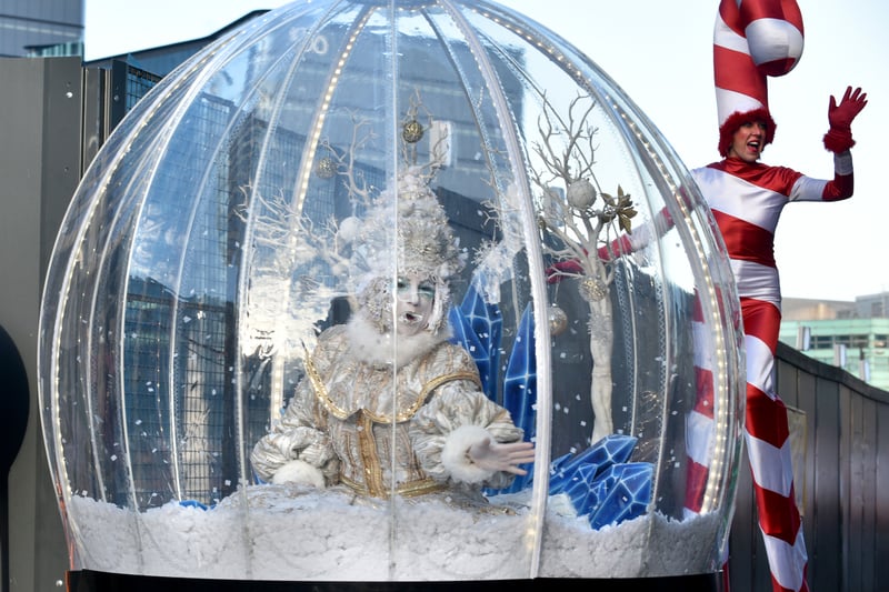 The giant snow globe with one of the candy cane stilt walkers. Photo: David Hurst