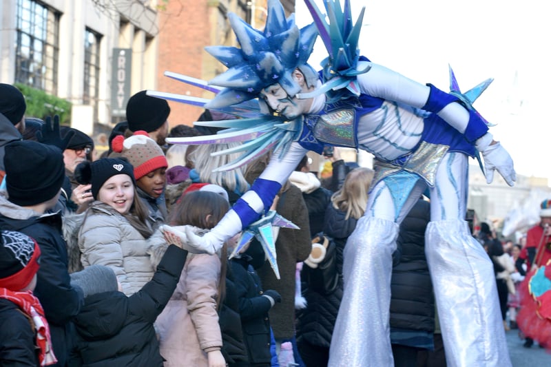 Jack Frost high-fives a young parade watcher. Photo: David Hurst