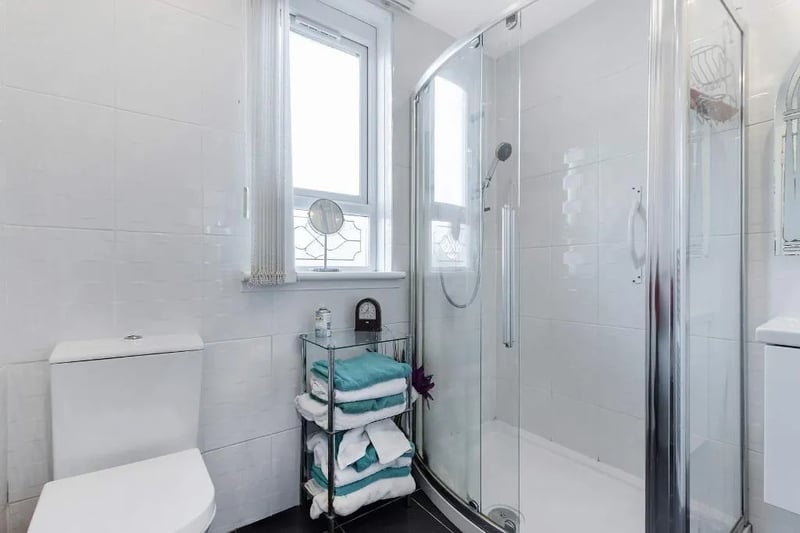 The modern shower room features sliding doors 