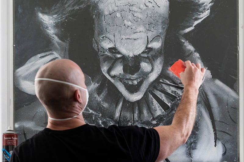 It’s not just the festive period which allows Scott to use his talent for snow art. Here he is creating a terrifying image of Pennywise the clown from Stephen King’s It for Halloween. Photo: Lee McLean/SWNS