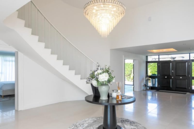 Upon entering, you’re greeted by a breath-taking entrance hall boasting a sweeping staircase.