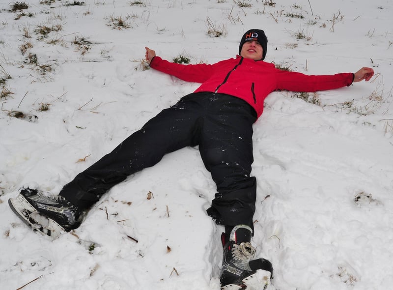 A member of the Peterborough Phantoms Ice Hockey Junior Academy makes snow angels in 2018.
