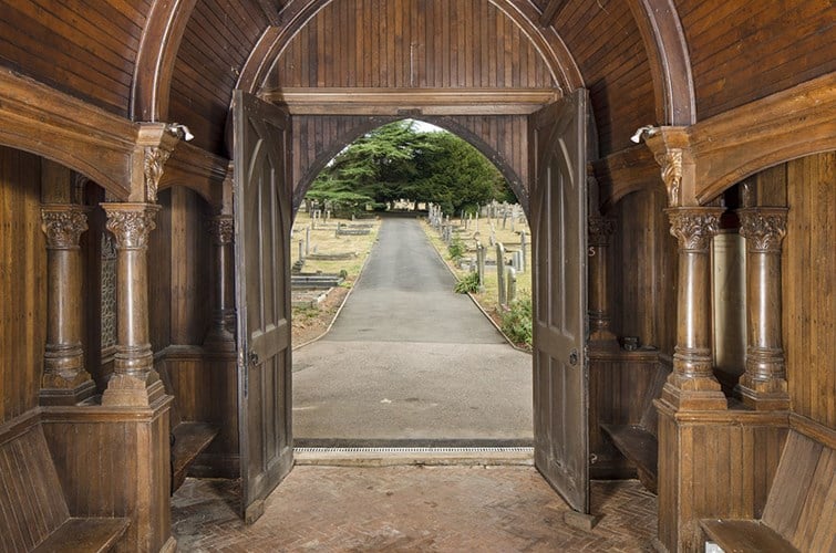 This grade II listed late 19th-century lych gate was built in 1894, a year after the cemetery opened. Designed in the Gothic Revival style, it has a steeply pitched roof and detailed carving on the large wooden front door, as well as wooden panels inside. (Photo: Historic England)
