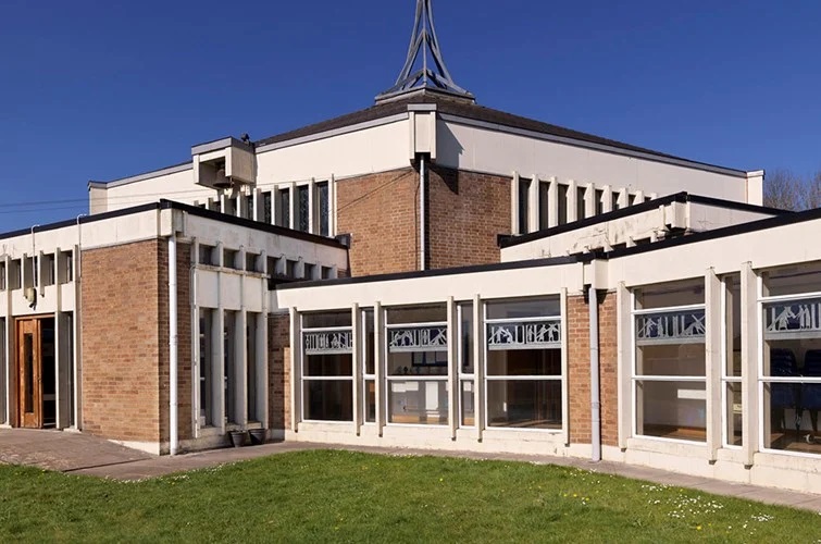 This grade II listed geometric-designed church was built in Chippenham the 1960s and features an extensive collection of work by British sculptor and stained-glass artist, Frank Roper MBE. (Photo: Historic England)

