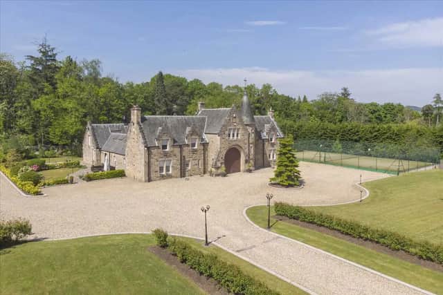 The Coachmans House includes a tennis court and woodland area