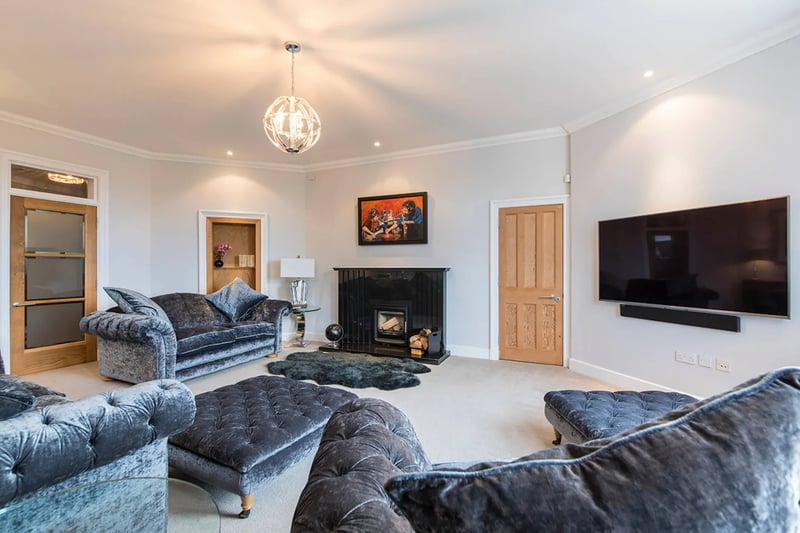 The spacious lounge features grand high ceilings which carry on throughout the property 