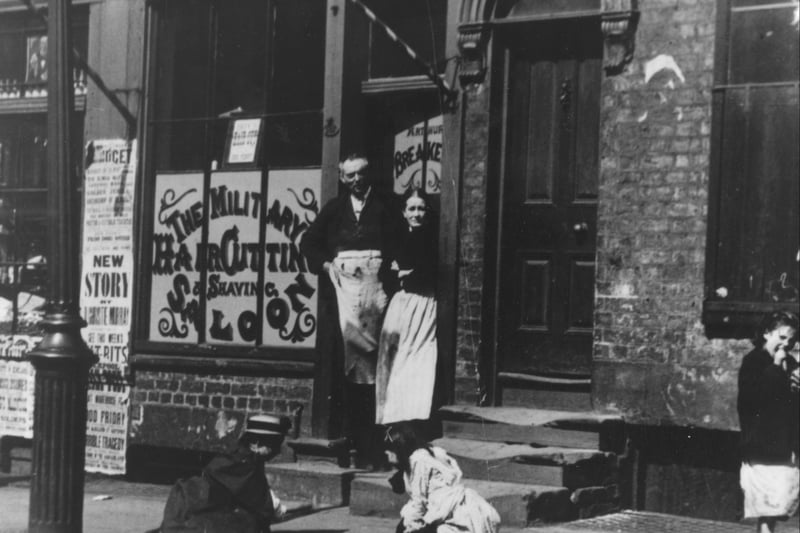  In a Liverpool street children are playing ‘Jacks and Allies’ outside a barber’s shop with its striped pole, circa 1890. (Photo by J. Burke/Hulton Archive/Getty Images)