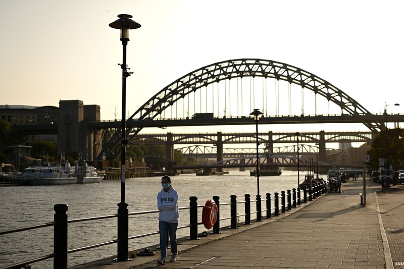 A woman walks along the Quayside wearing a face mask with the Tyne Bridge in the background in September 2020 as the country continue to battle Covid-19.