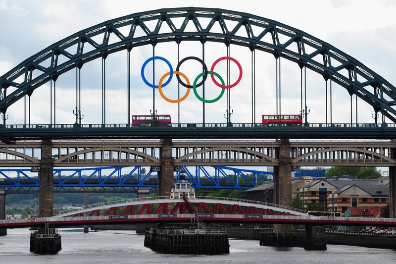 A London bus crosses the Tyne Bridge as the city of Newcastle prepares for the Olympic Torch Relay by displaying the Olympic rings on the landmark .