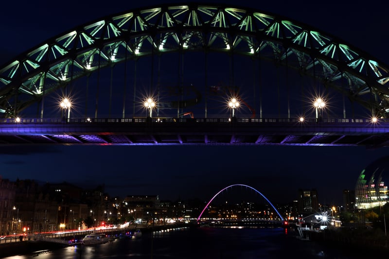 The Tyne Bridge and Gateshead Millennium Bridge shine blue, white and red after a terrorist attak in Nice, France in 2016.