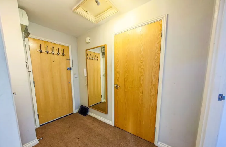 The entrance and exit of the flat, with a wide entrance and plenty of hangers