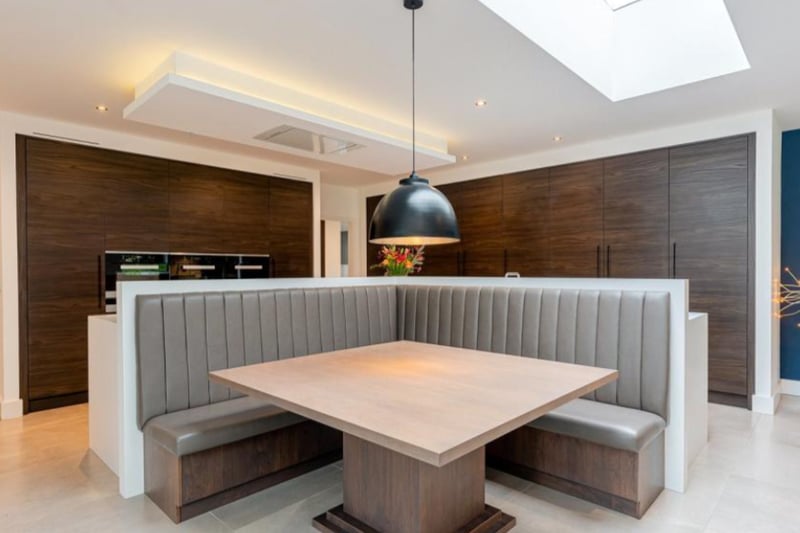 The kitchen worktops double as a sleek seating area. 