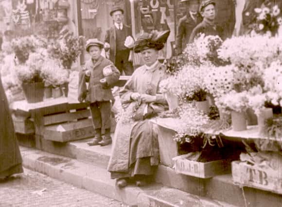 This image shows a flower stall at Stockport market circa 1910