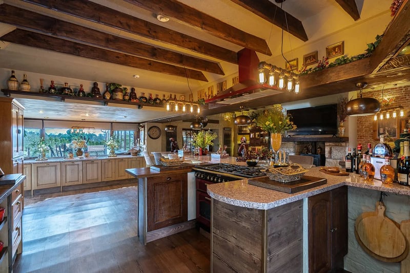 Decorated in a truly traditional rustic manner, the kitchen space is fully equipped with exposed beams, breakfast bar, wine fridge & pizza oven.
