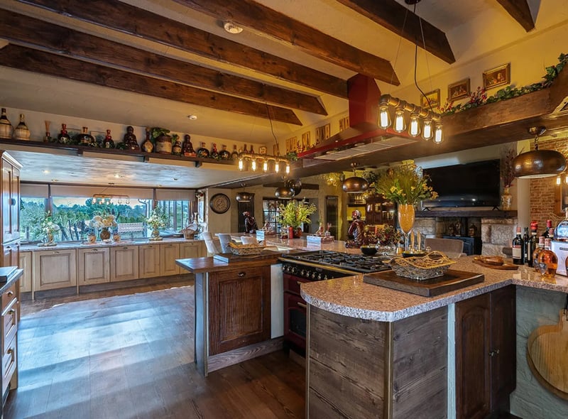 Decorated in a truly traditional rustic manner, the kitchen space is fully equipped with exposed beams, breakfast bar, wine fridge & pizza oven.