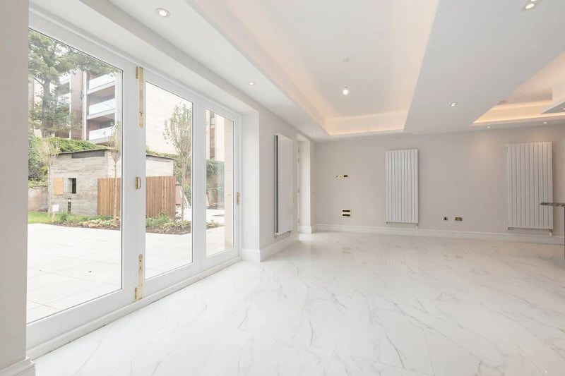 The kitchen is floored with marble and offers direct access to the garden 