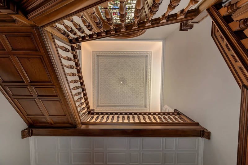 The winding staircase is complimented by grande high ceilings