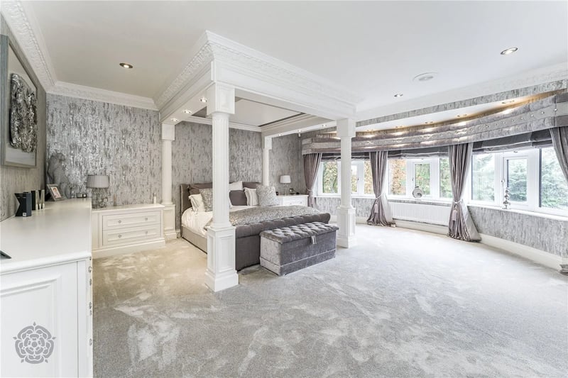 Large bedroom with pillars.