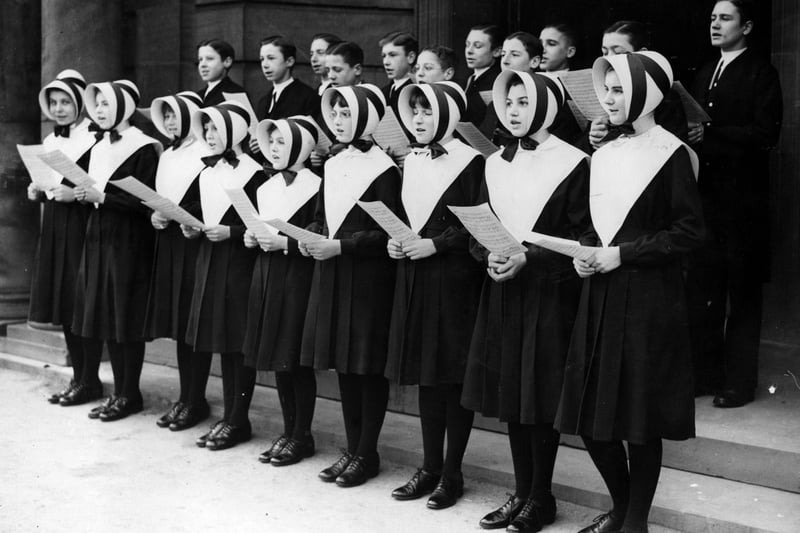 Girls and boys of the Blue Coat Hospital school in Liverpool sing Christmas carols. 