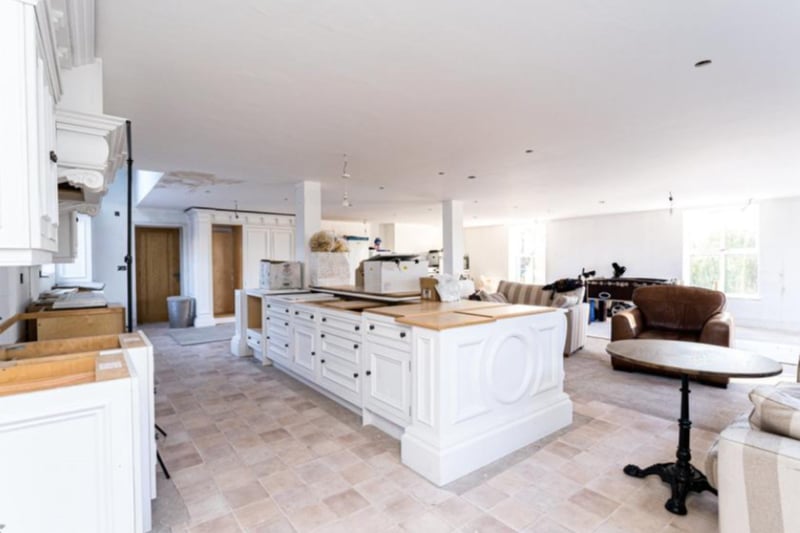 There is a huge open-plan breakfast kitchen, with an ideal workspace and sitting area.