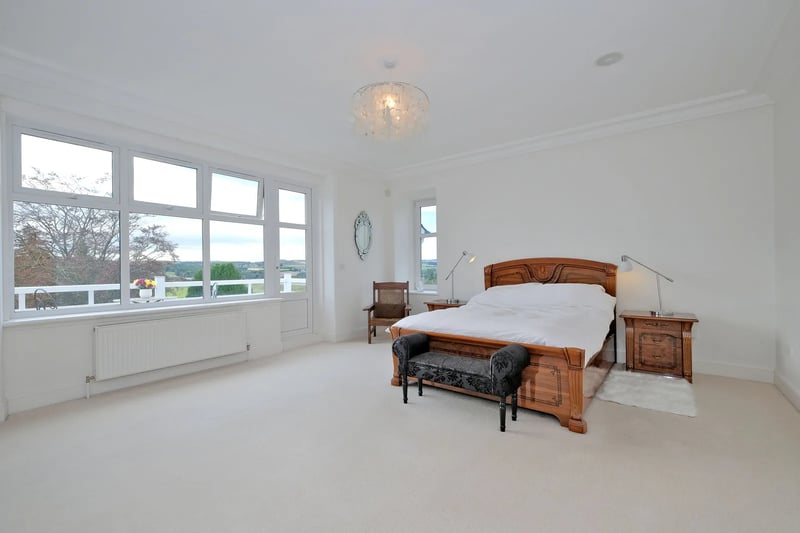 The master bedroom features southerly views, a picture window and French doors to the balcony