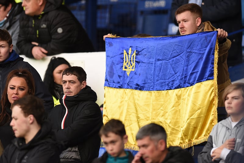 An Everton fan raises a Ukraine flag after Russia’s invasion of the country in February.