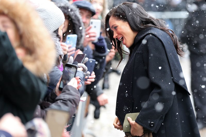 Meghan, Duchess of Sussex meets well-wishers as the snow falls as she arrives to visit Bristol Old Vic theatre