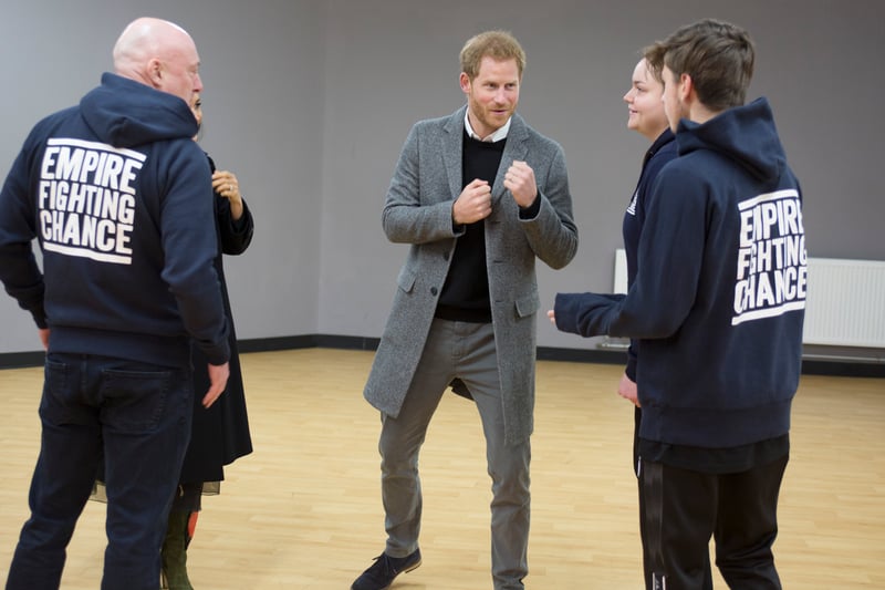 Prince Harry, Duke of Sussex, has some fun as he chats with Lestyn Jones and Sarah Lucey during a visit to the Boxing Charity, Empire Fighting Chance
