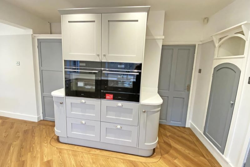 The kitchen has fitted appliances and ample space for a dining table.