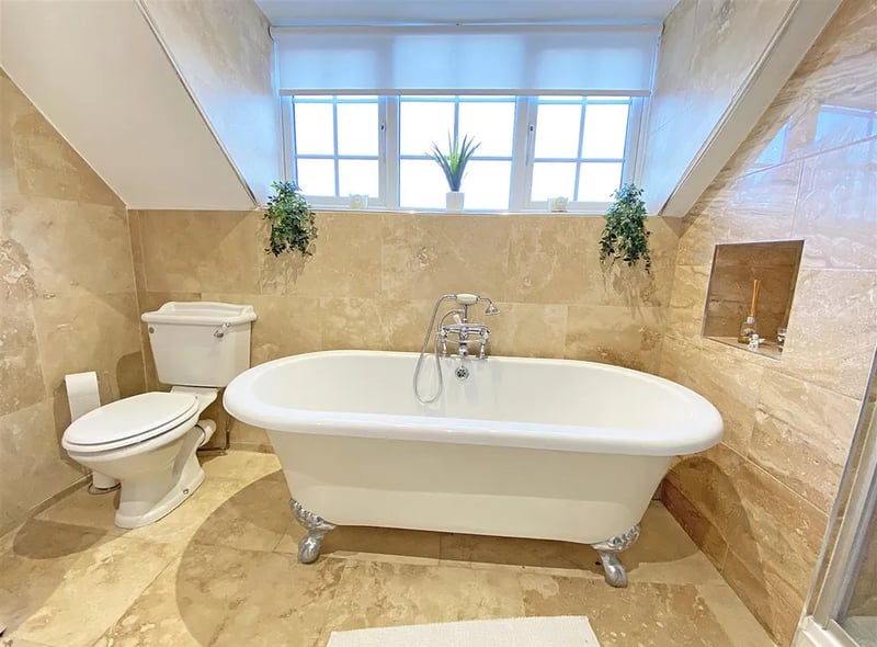 Stunning bathroom with free standing bath in property