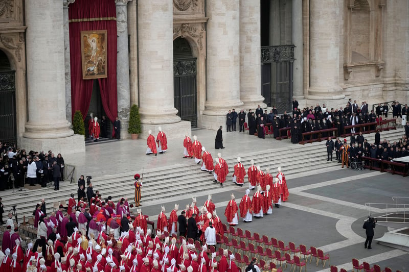Clergy walk towards St Peterâs Basilica for the burial of Pope Emeritus Benedict XVI after the funeral mass at St. Peter’s square