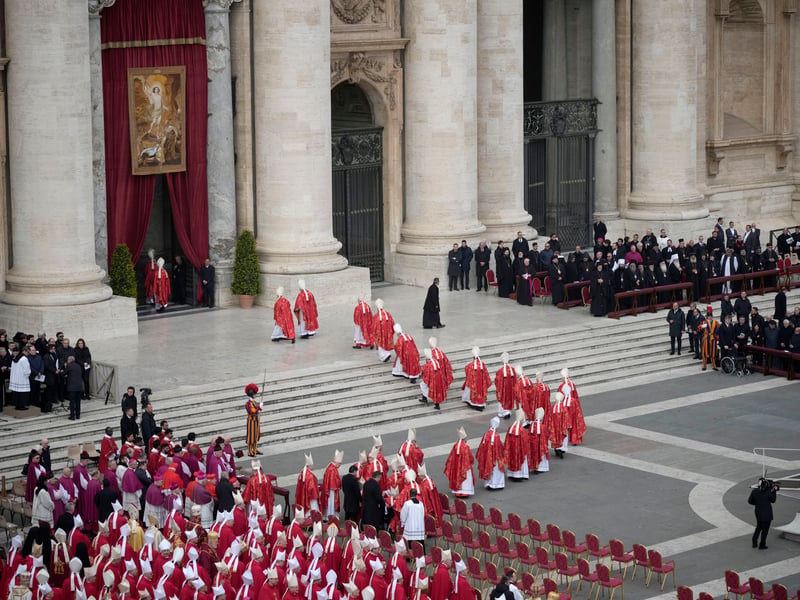 Clergy walk towards St Peterâs Basilica for the burial of Pope Emeritus Benedict XVI after the funeral mass at St. Peter’s square
