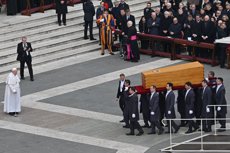 Pallbearers carry the coffin of Pope Emeritus Benedict XVI in front of Pope Francis at the end his funeral mass at St. Peter’s square in the Vatican