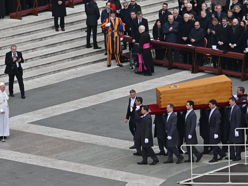 Pallbearers carry the coffin of Pope Emeritus Benedict XVI in front of Pope Francis at the end his funeral mass at St. Peter’s square in the Vatican