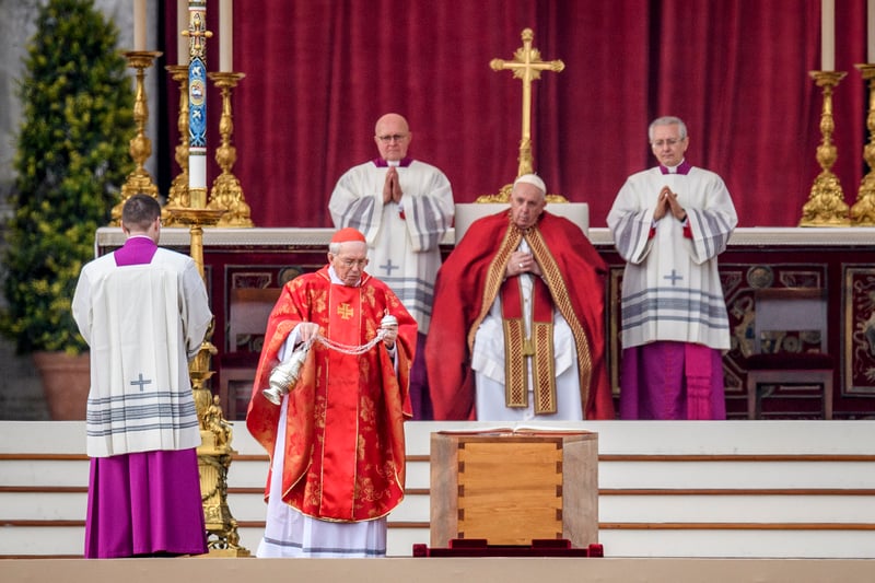 Cardinal Giovanni Battista Re swings a thurible of incense on the coffin of Pope Emeritus Benedict XVI during the funeral mass at St. Peter’s square