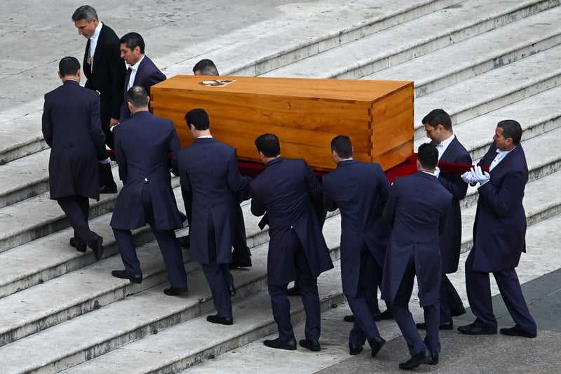 Pallbearers carry away the coffin of Pope Emeritus Benedict XVI at the end of his funeral mass at St. Peter’s square in the Vatican