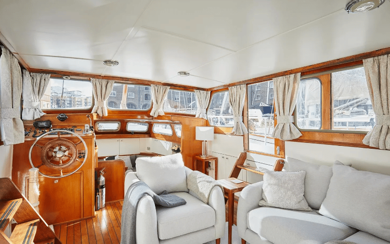 Another area of the boat with mostly windows, showcasing how much light can be let in but multiple curtains if you wish to have some privacy