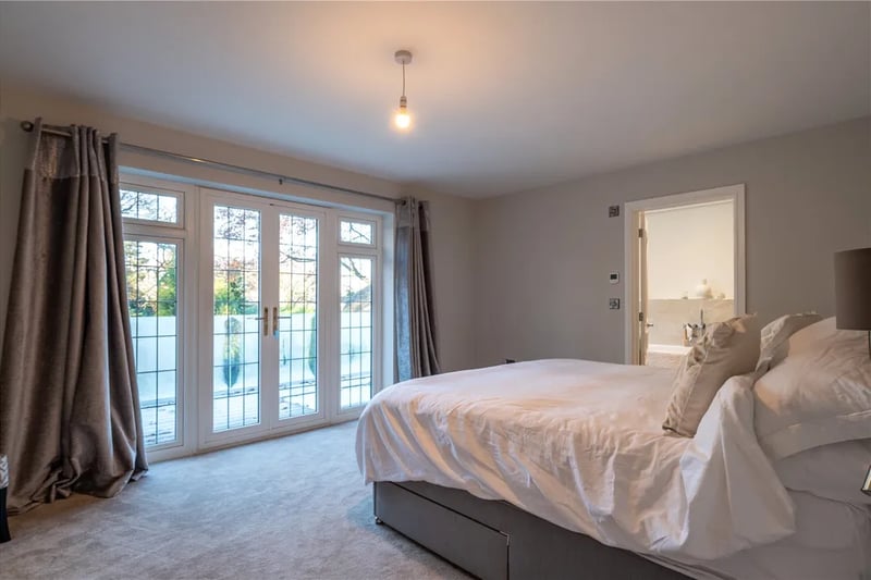 One of the master bedrooms with a balcony overlooking the garden